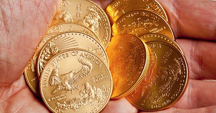 Hand holding American Gold Eagle Coins